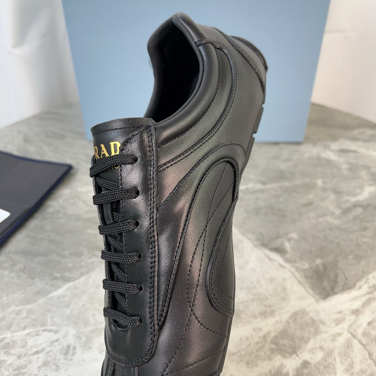 PRADA 25S MONTECARLO ANTIQUED SNEAKERS IN BLACK NAPPA LEATHER
